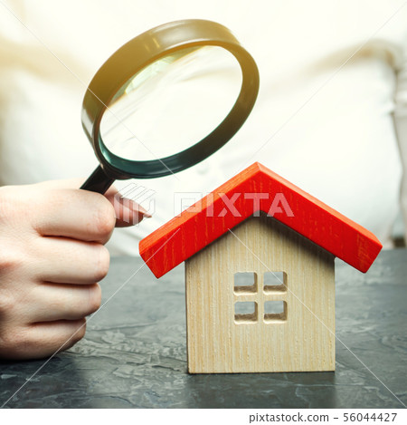 A woman is holding a magnifying glass 56044427