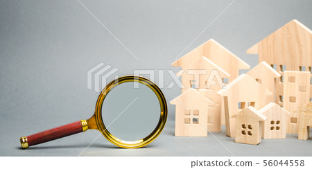 Magnifying glass and wooden houses. House 56044558