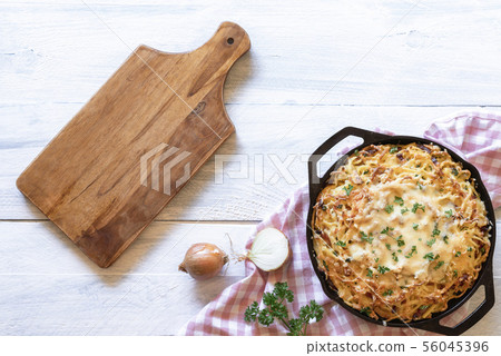 German cheese pasta and empty wooden cutting board German cheese pasta and empty wooden cutting board 56045396