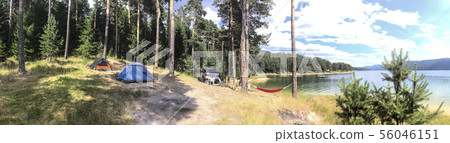 Panoramic image of forest and mountain lake. Tents 56046151