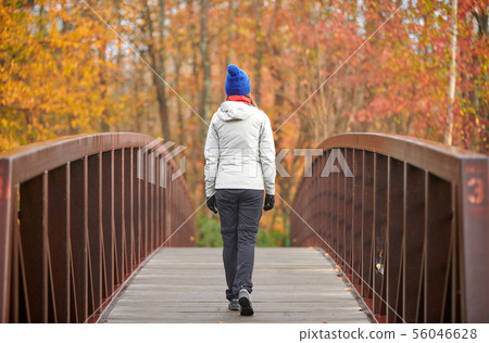 Woman hiking at autumn day Woman hiking at autumn day 56046628