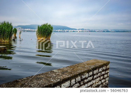 Tranquility of morning waters of Pamvotida, Greece Tranquility of morning waters of Pamvotida, Greece 56046763
