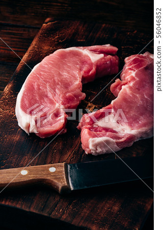 Two pork loin steaks with knife Two pork loin steaks with knife 56046852