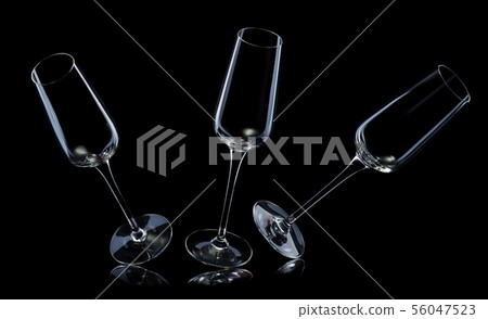 Set of empty luxury champagne glasses in a row isolated on a black background Set of empty luxury champagne glasses in a row isolated on a black background 56047523