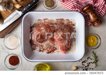 rubbing santa maria style sauce on tri-tip steak 56047655