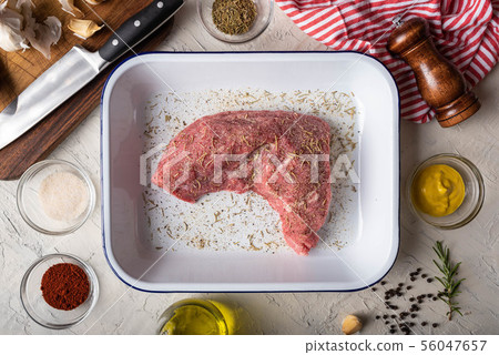rubbing santa maria style sauce on tri-tip steak 56047657