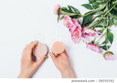 Top view woman's hands holding makeup puff 56050392