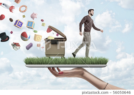 Side view of young man walking away from open dumpster and avalanche of waste in air, on grass 56050646