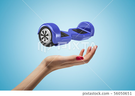 Female hand with blue hoverboard above on blue background 56050651