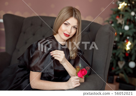 Happy New Year to you.One beautiful young woman in a black dress and bright makeup celebrating Happy New Year to you.One beautiful young woman in a black dress and bright makeup celebrating 56052021