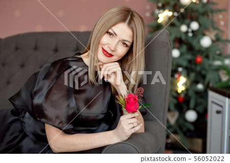 Happy New Year to you.One beautiful young woman in a black dress and bright makeup celebrating Happy New Year to you.One beautiful young woman in a black dress and bright makeup celebrating 56052022