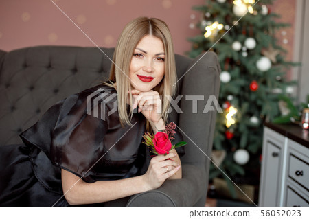 Happy New Year to you.One beautiful young woman in a black dress and bright makeup celebrating Happy New Year to you.One beautiful young woman in a black dress and bright makeup celebrating 56052023