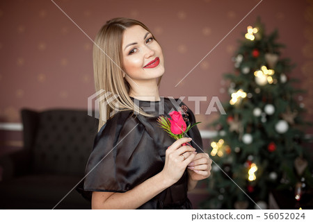Happy New Year to you.One beautiful young woman in a black dress and bright makeup celebrating 56052024