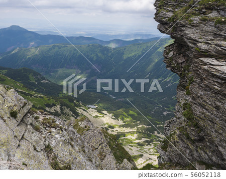 Beautiful vivid blue mountain lake Rohacske pleso with green mountain peaks and hiking path. view 56052118