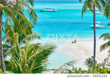Toddler boy on beach with mother Toddler boy on beach with mother 56052292