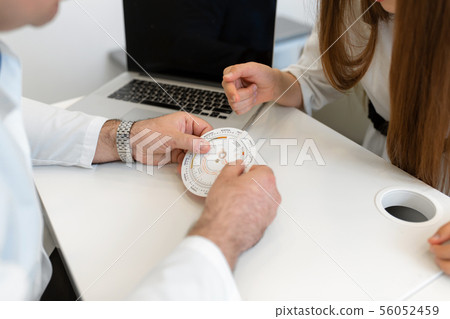 Male gynecologist explaining young girl menstrual Male gynecologist explaining young girl menstrual 56052459