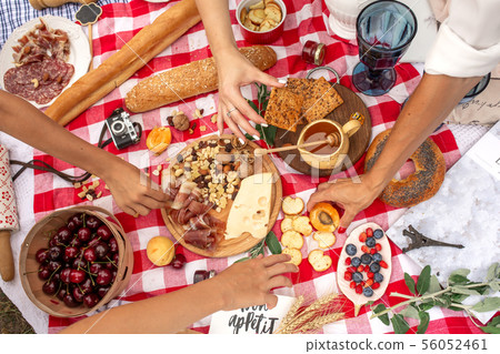 Top view people take food from checkered picnic 56052461