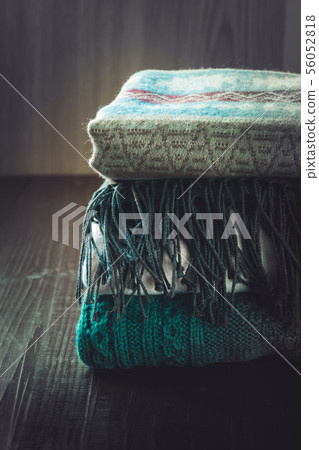 Autumn composition with warm sweater on wooden board. 56052818