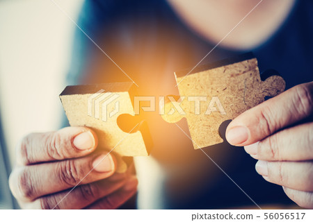 Business people are taking puzzles to connect. 56056517