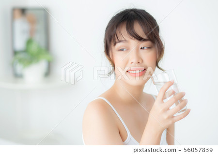 Beautiful portrait young asian woman drink water Beautiful portrait young asian woman drink water 56057839