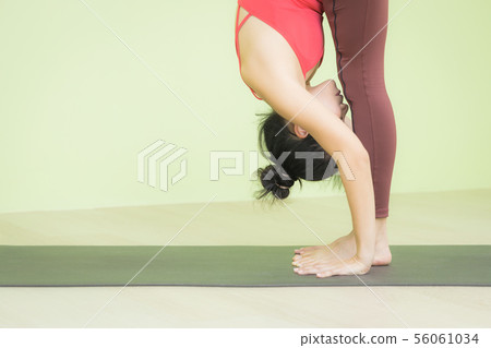 Woman standing forward bend pose yoga. 56061034