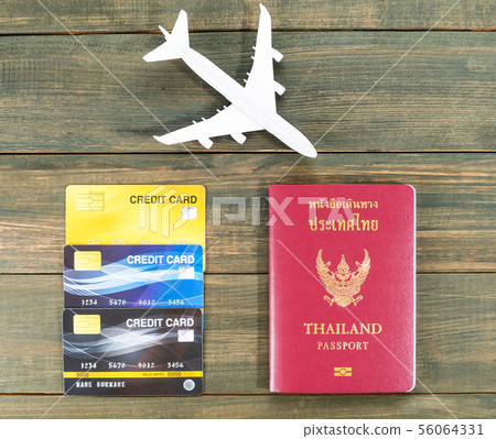 Passport with credit card on brown wooden Passport with credit card on brown wooden 56064331