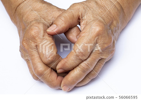 Senior woman's grasping her hands, wrinkled skin 56066595