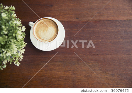 Coffee cup and small tree decorate on wooden table Coffee cup and small tree decorate on wooden table 56076475