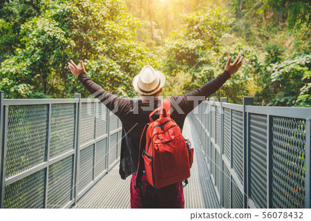 traveling backpacker walking on Canopy walkway at traveling backpacker walking on Canopy walkway at 56078432