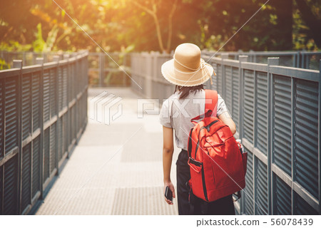traveling backpacker walking on Canopy walkway at 56078439