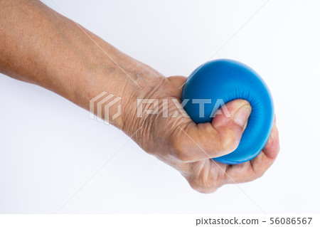 Senior woman's hand squeezing blue stress ball 56086567