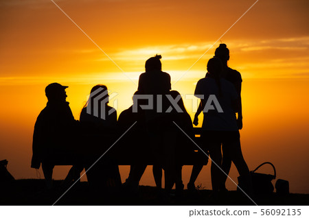 Evening silhouette, hopeful young people 56092135