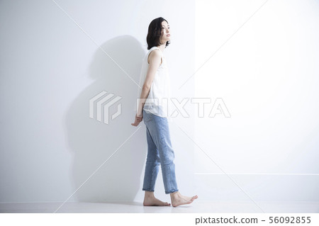 Woman walking with folded hands Woman walking with folded hands 56092855