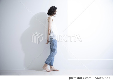 Woman walking with folded hands 56092857