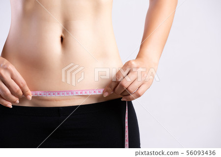 Closeup of woman showing on her belly dark scar Closeup of woman showing on her belly dark scar 56093436