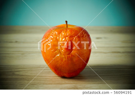 Business term A rotten apple on a table An employee who does not play a role. Business term A rotten apple on a table An employee who does not play a role. 56094191