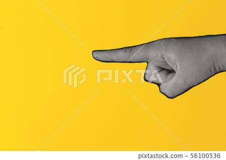 Woman hand pointing on bright yellow background. Woman hand pointing on bright yellow background. 56100536