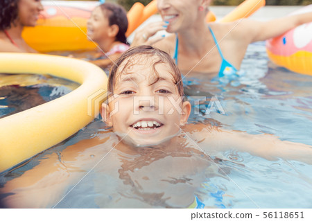 Boy swimming in pool 56118651