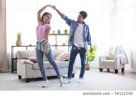 Romantic teen african american couple dancing at home Romantic teen african american couple dancing at home 56122598