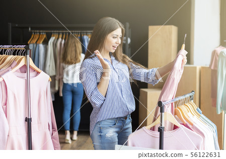 Happy girl finally found shirt she was looking for Happy girl finally found shirt she was looking for 56122631