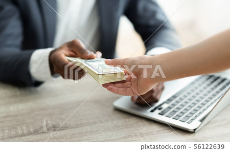 Company leader giving money bonus to office worker Company leader giving money bonus to office worker 56122639