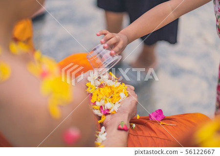 People pouring water to Buddhist Monk People pouring water to Buddhist Monk 56122667