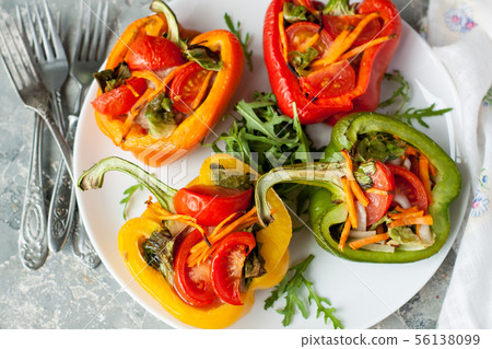 Baked bell peppers stuffed with vegetables 56138099