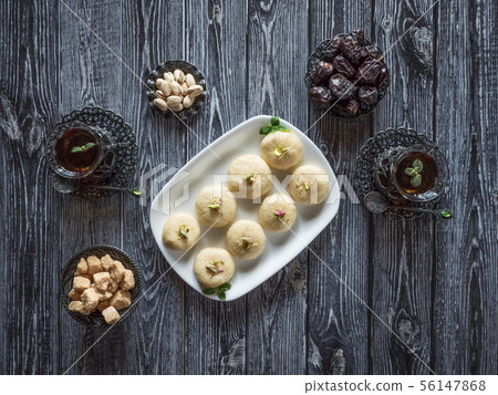 Peda (Indian sweet), Milk Fudge with tea cups  56147868