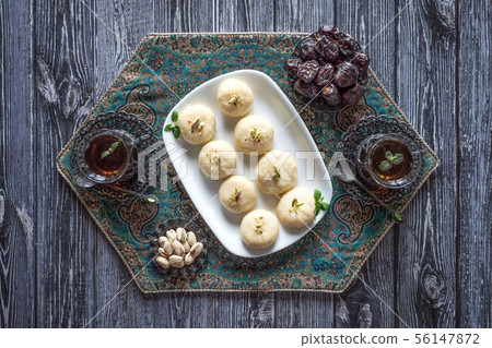 Peda (Indian sweet), Milk Fudge with tea cups  56147872