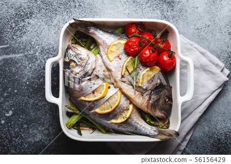 Fish dorado baked with asparagus 56156429