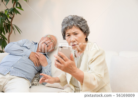 Senior, sudden illness, smartphone usage Senior, sudden illness, smartphone usage 56169809