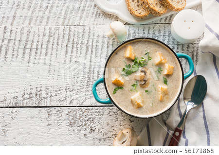 Mushroom champignon cream soup on white wooden board. View from above. Space for text. Mushroom champignon cream soup on white wooden board. View from above. Space for text. 56171868