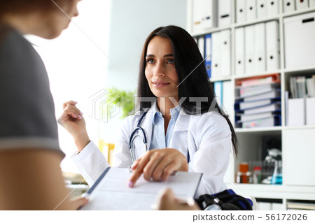 Beautiful caucasian female GP pointing finger in application form Beautiful caucasian female GP pointing finger in application form 56172026