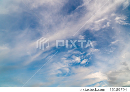 White clouds on a background of blue sky on a day. 56189794